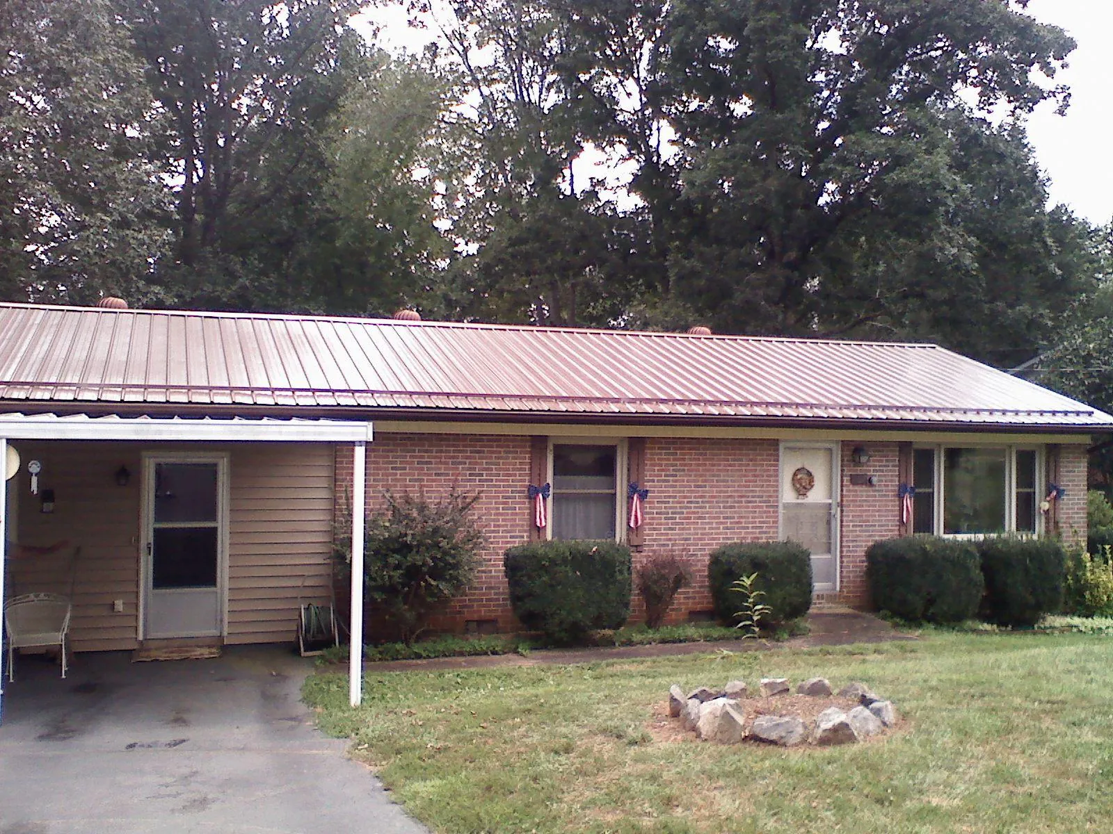 Bronze metal roof and carport on a brick ranch home — Roof Repair work by our crew in Mahopac Falls