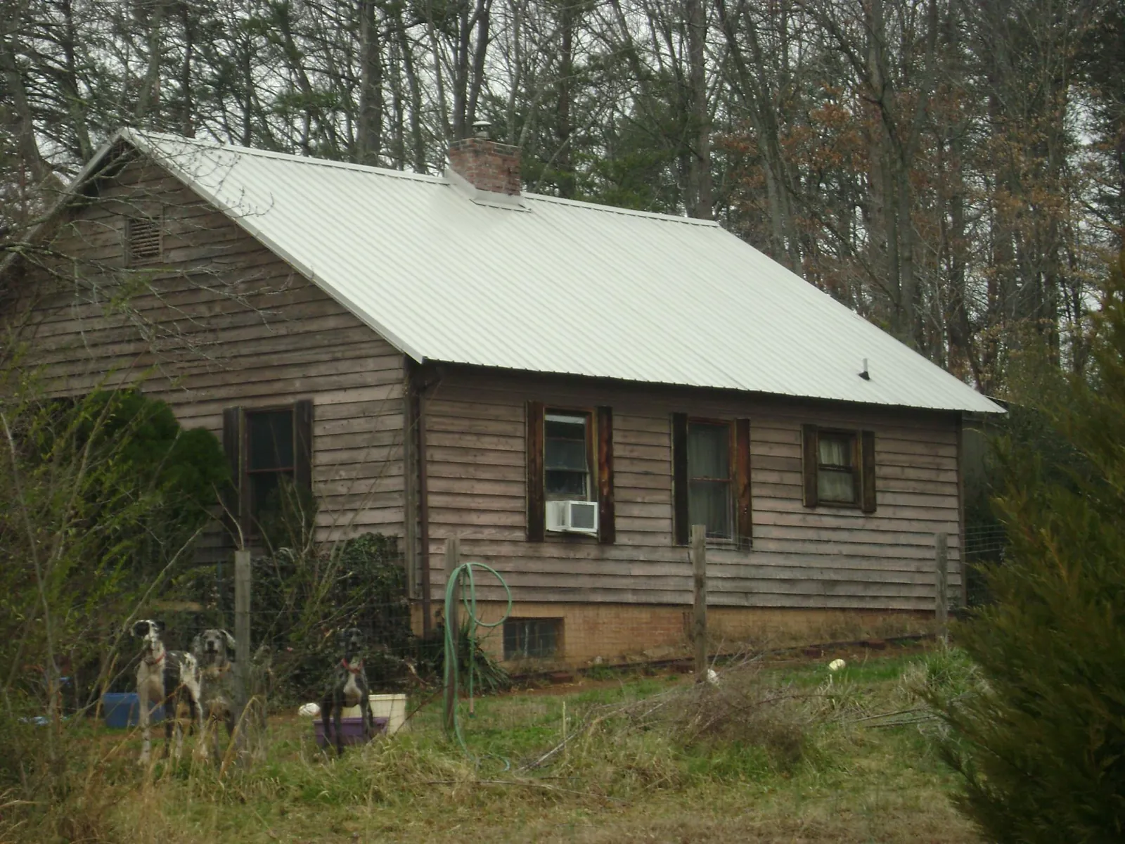 White metal roof on an old wood sided farmhouse, from a Metal Roof Installation job in Mahopac Falls